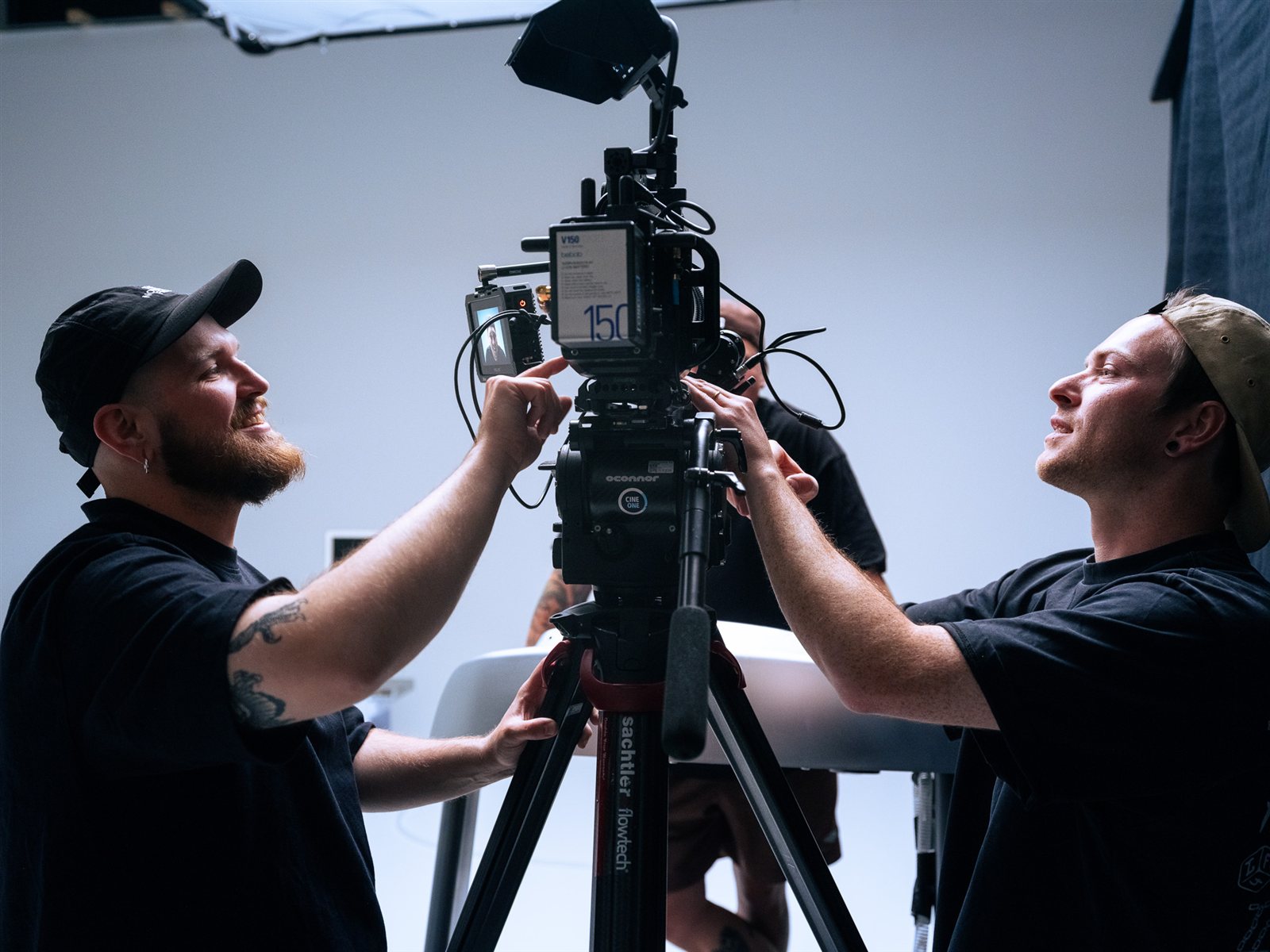Crew prepping a GFX ETERNA 55 rig on a white cyc