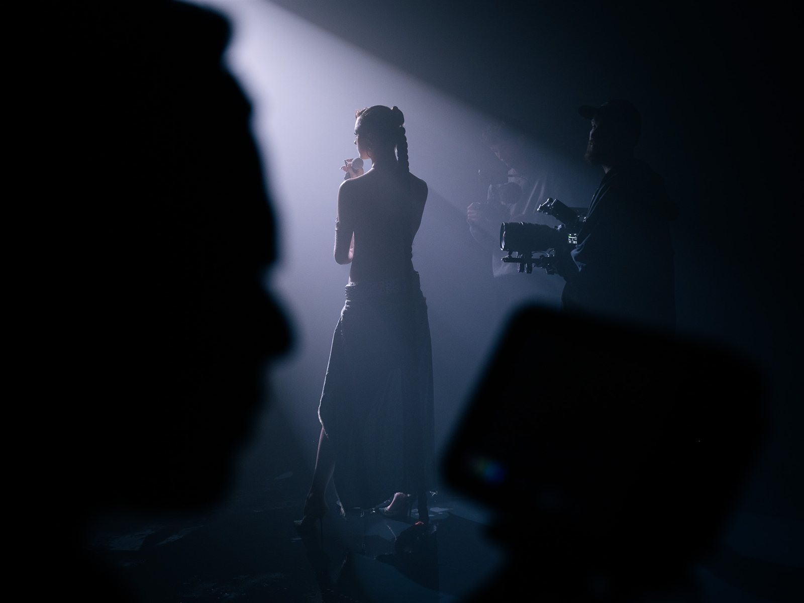 Silhouetted film set with the camera crew at work