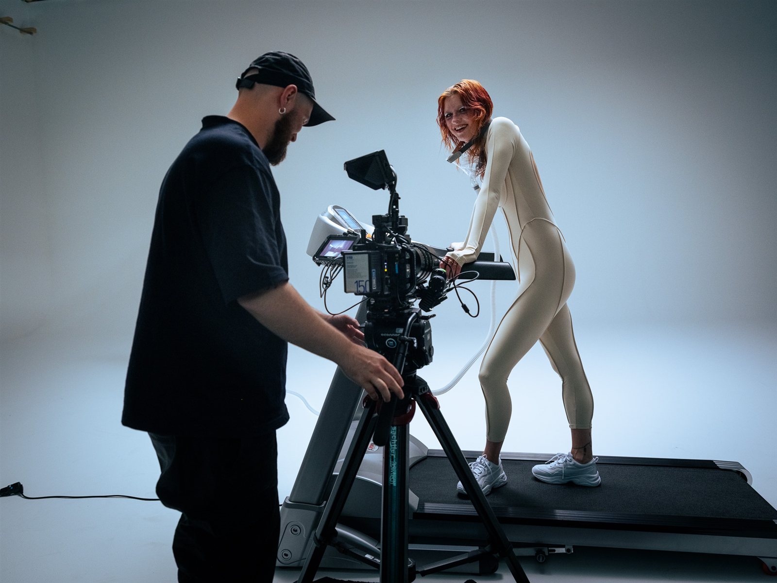 Filming on the white cyc with the GFX ETERNA 55 — artist mid-take on a treadmill